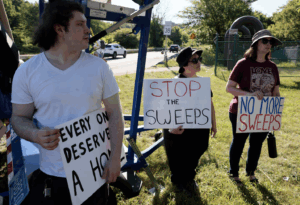 Protesters outside of the Dog Park homeless encampment in Lowell, MA. Members of Solidarity Lowell and LLAMA were there.